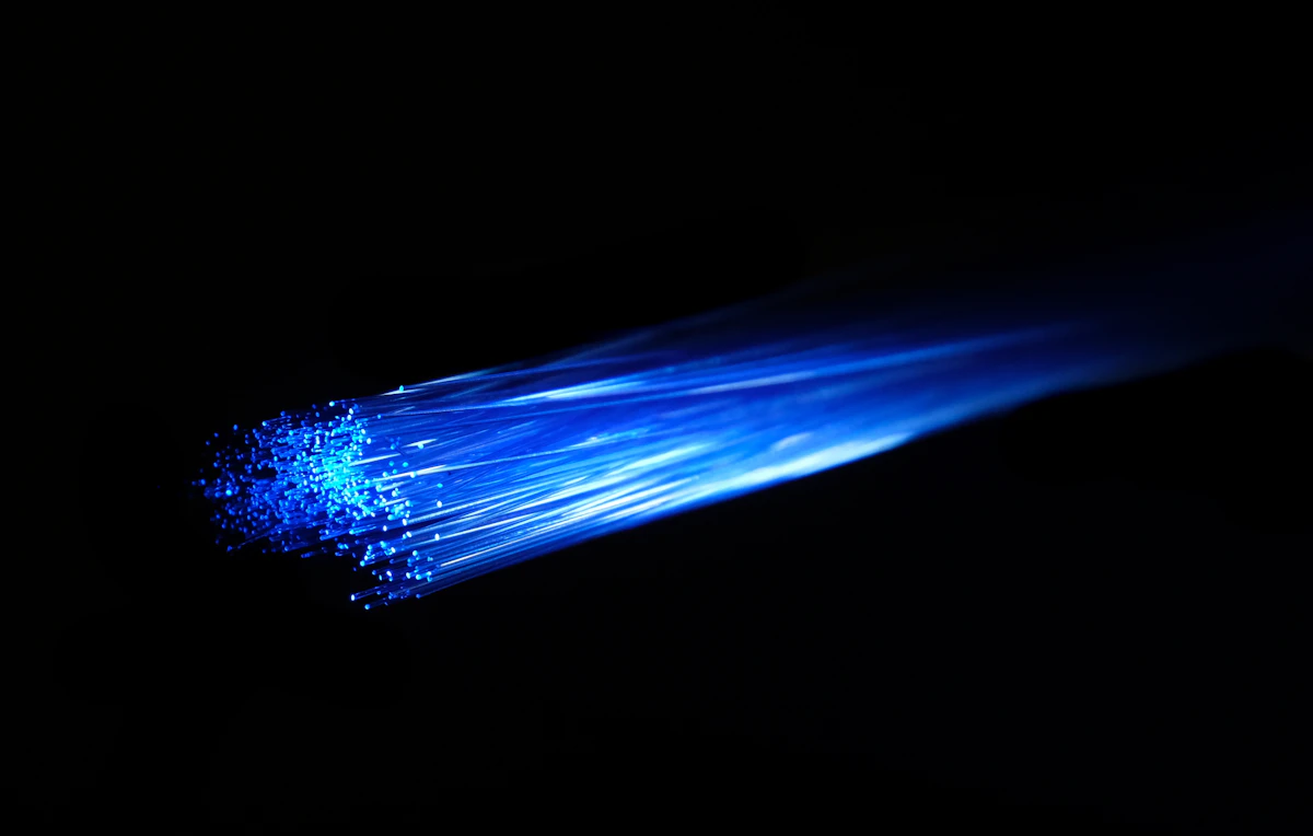Blue light passing through optical fibres, illustrating connection and data flow
